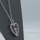 Load and play video in Gallery viewer, Jewelili Sterling Silver With Natural White Round Diamonds Cross Heart Pendant Necklace
