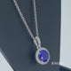 Load and play video in Gallery viewer, Jewelili Sterling Silver With Created Blue Sapphire and Created White Sapphire Halo Pendant Necklace
